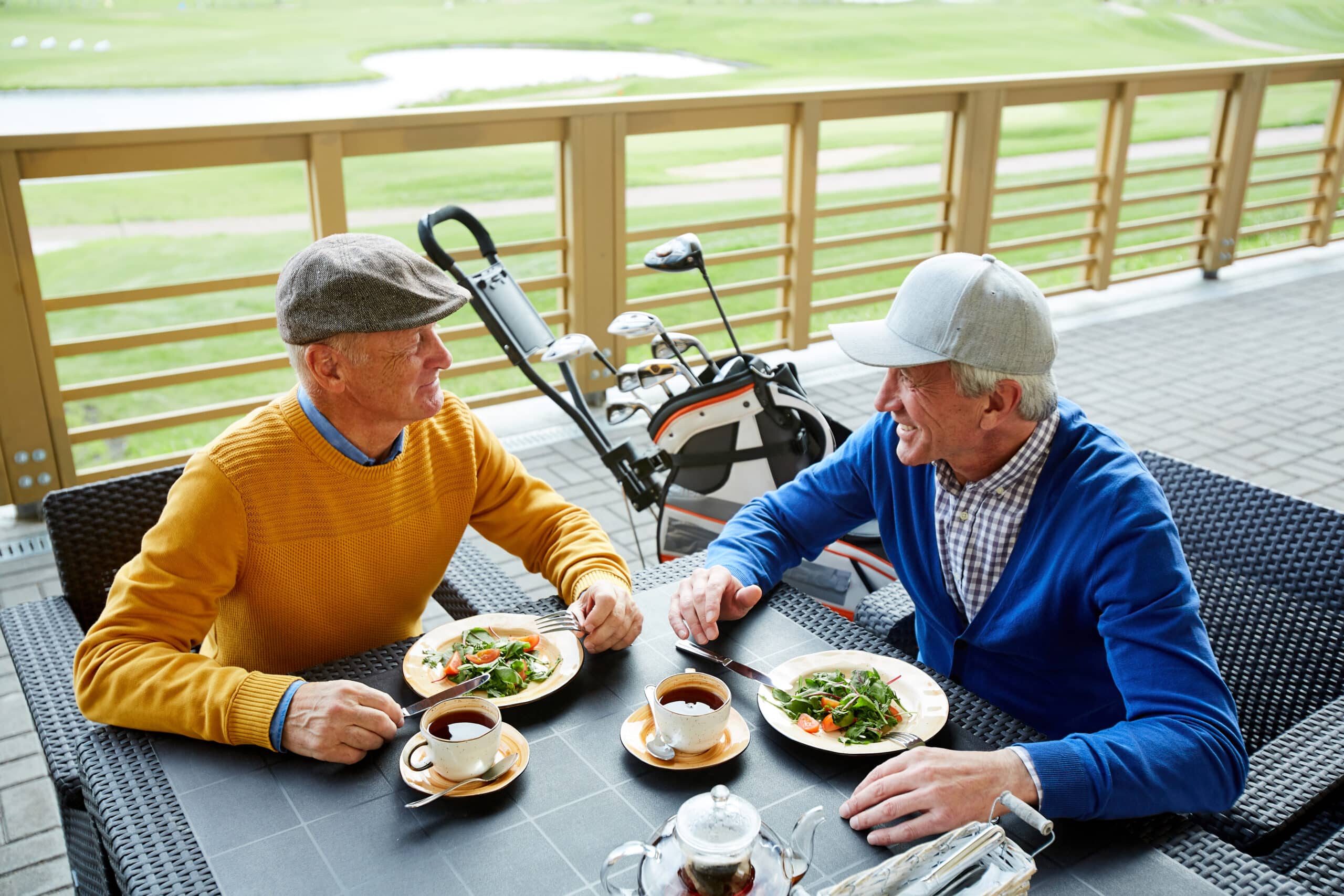 Golf in Laguna Phuket: Things to Do After a Round 1 Golf in Laguna Phuket: Two senior golfers enjoying a meal at the clubhouse