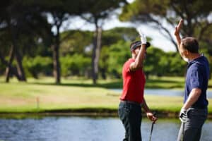 perfect golf holiday in Phuket: Two golfers high-fiving on the course.