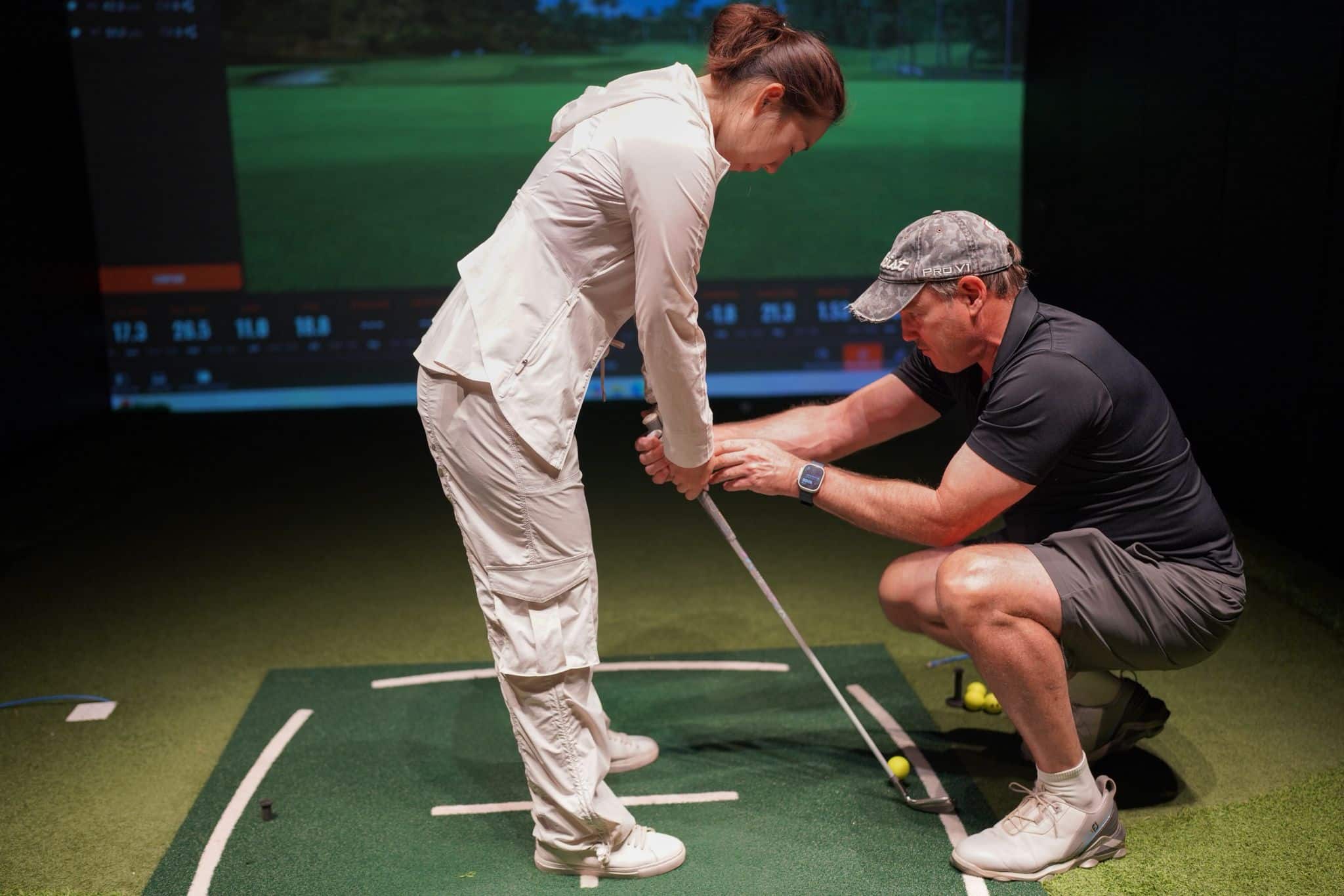 A stunning aerial view of Laguna Golf Course in Phuket, showcasing lush greens, a tranquil lake, and residential villas by the seaside.