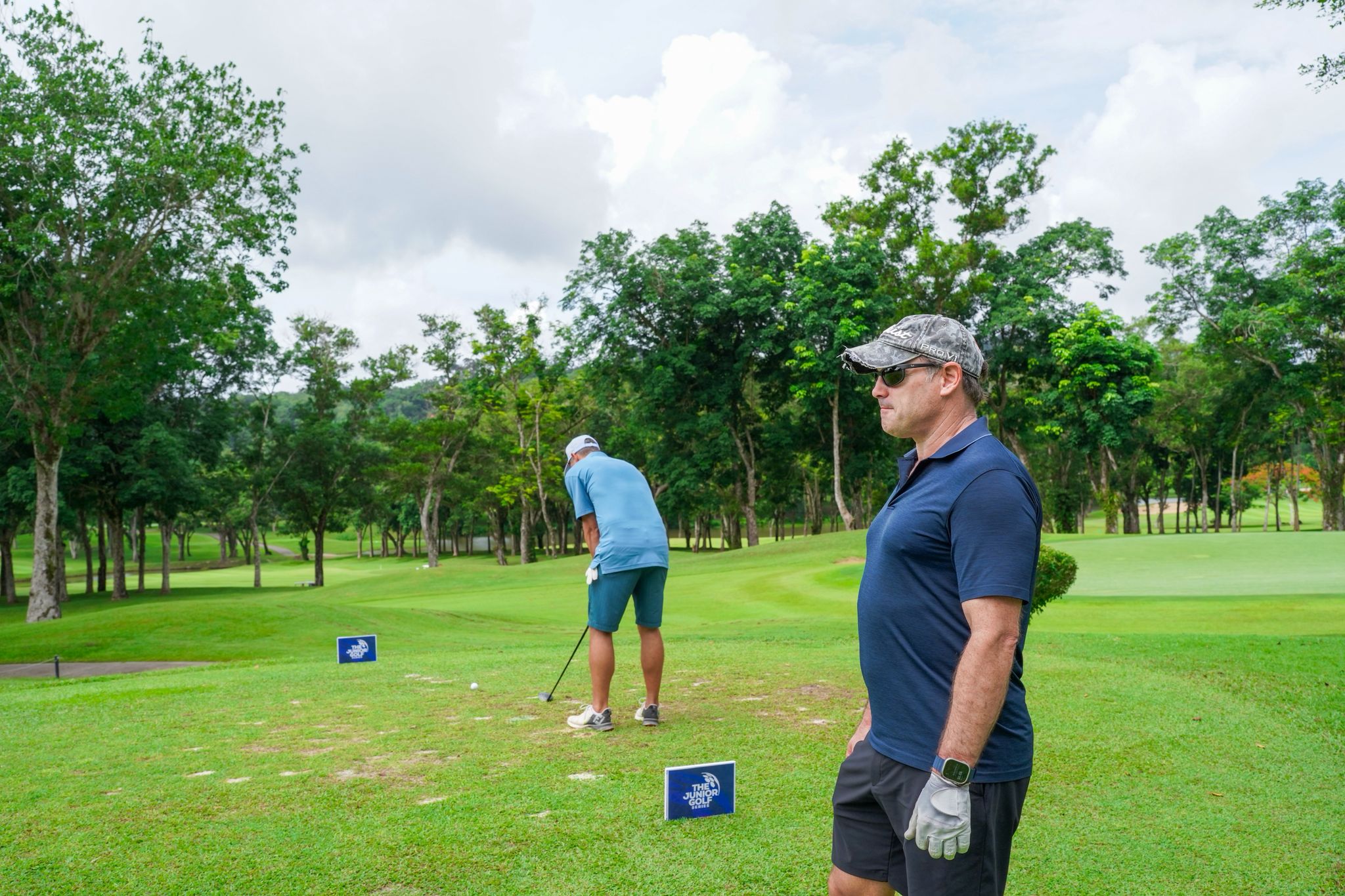 An expansive aerial view of Laguna Golf Course in Phuket, showcasing vibrant fairways, water features, and nearby coastal villas.